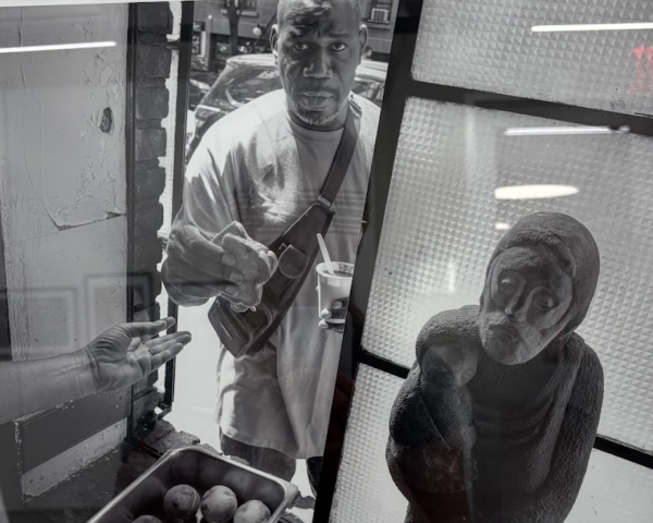 This photo included in the exhibit shows the bread line outside the window of the Catholic Worker in the Lower East Side. (Erynn Sweeney/The Fordham Ram)